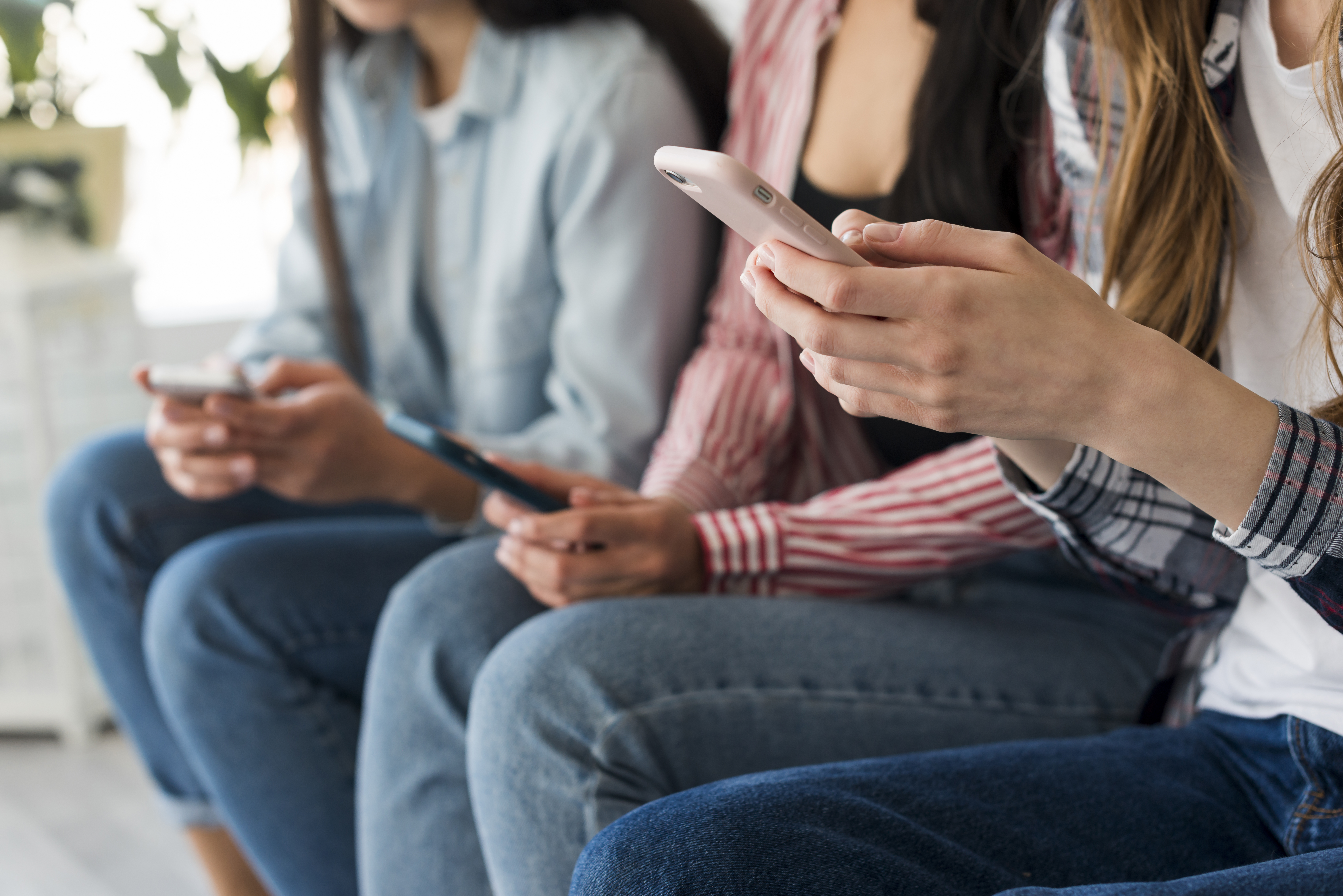 close up of women holding cell phones